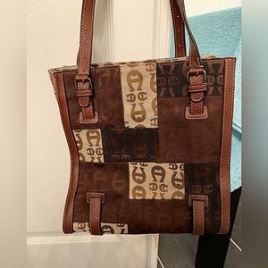 Etienne Aigner brown, tan/black purse with leather straps and piping 10” x 11”